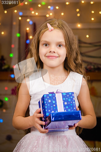 Image of Five-year girl with Christmas gifts in his hands