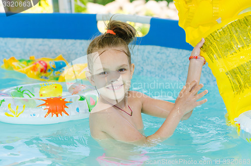 Image of Six year old girl bathing in pool