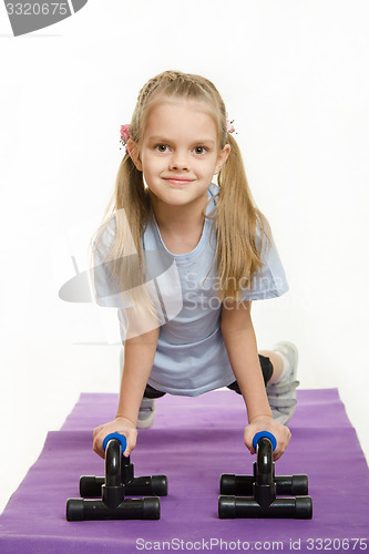 Image of Six year old girl pushed with stops for push-ups