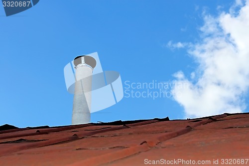 Image of Chimney pipe over the old tinny roof