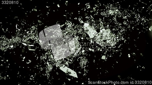 Image of Shattered and cracked glass on black background