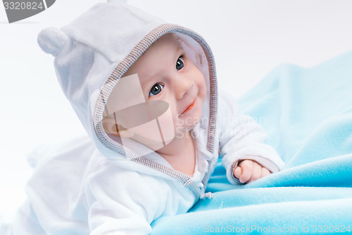 Image of baby in the hood on a blue blanket