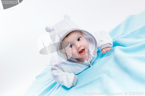 Image of baby in the hood on a blue blanket