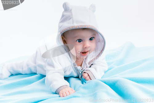 Image of baby in the hood on a blue blanket