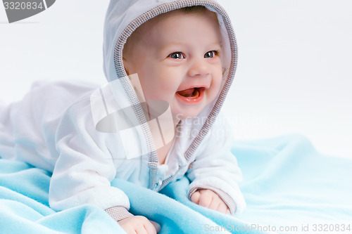 Image of baby in the hood on a blue blanket