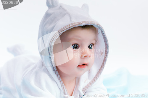 Image of baby in the hood on a blue blanket