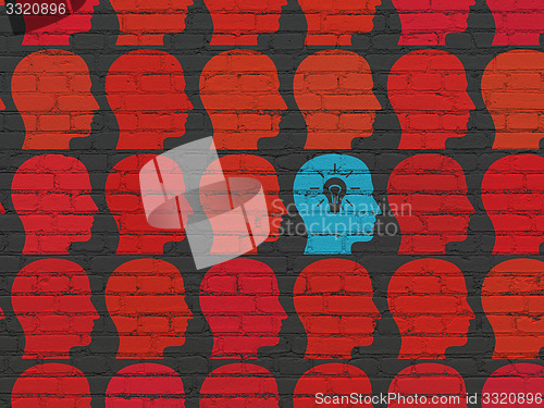 Image of Business concept: head with light bulb icon on wall background