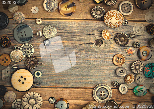 Image of set of vintage buttons on aged wooden boards