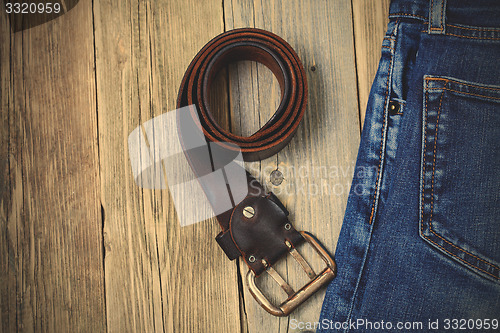 Image of Vintage blue jeans and old leather belt