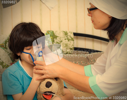 Image of doctor spends boy inhalation
