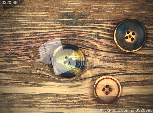 Image of three old buttons
