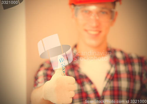 Image of worker showing thumb up
