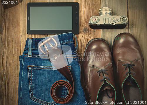 Image of digitizer, rangefinder camera, brown boots, leather belt and blu