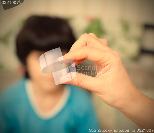 Image of doctor with pill and boy