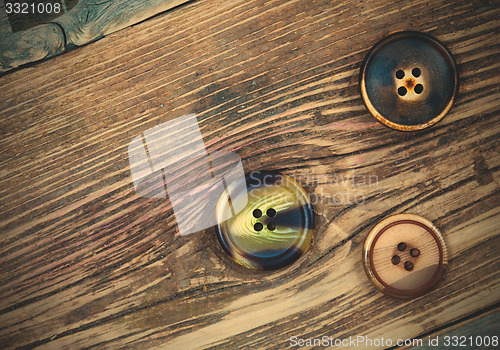 Image of three aged buttons