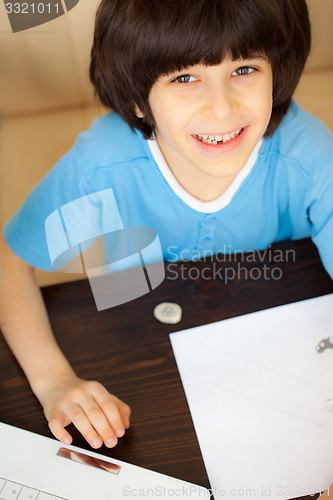 Image of smiling child doing homework