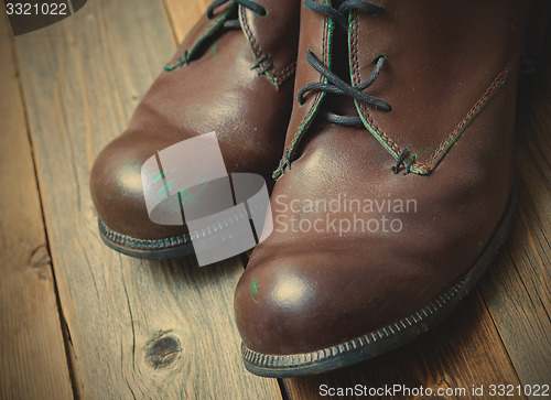 Image of Two brown boots on old boards