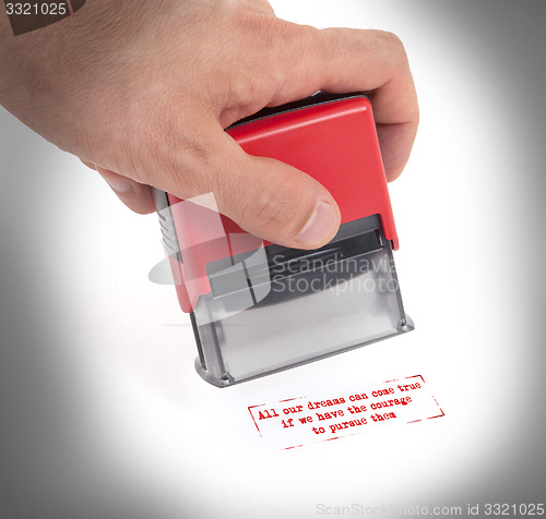 Image of Plastic stamp in hand, isolated