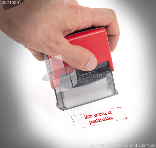 Image of Plastic stamp in hand, isolated