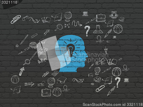 Image of Learning concept: Head With Light Bulb on wall background