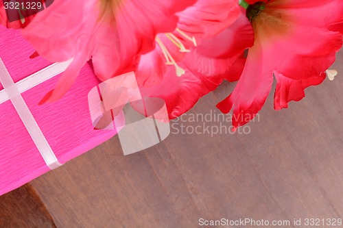 Image of present gift box and flower bouquet on silk