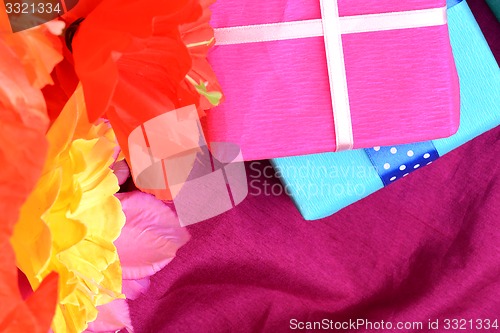 Image of present gift box and flower bouquet on silk