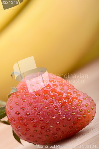 Image of healthy strawberry smoothie with fruits on wooden background