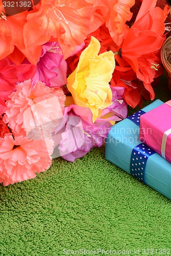 Image of present gift box and flower bouquet on silk