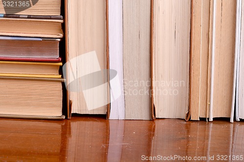 Image of Old books leaning against each other for sale