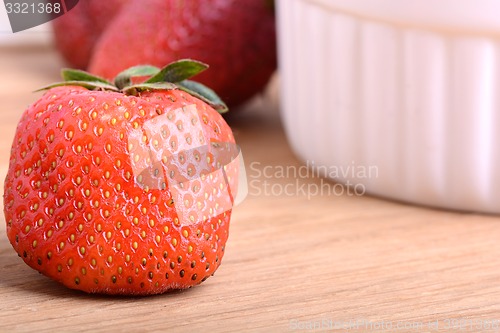 Image of Close up strawberry on wooden plate