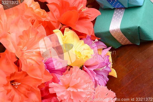 Image of present gift box and flower bouquet on silk