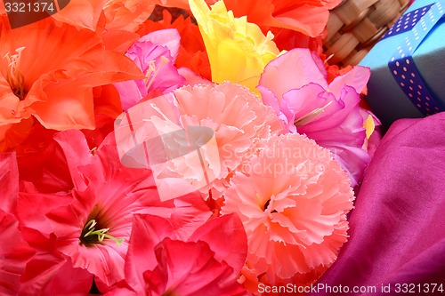 Image of present and flower bouquet on silk