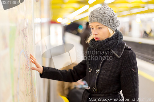 Image of Lady looking on public transport map panel.