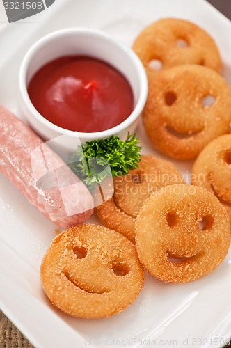 Image of sausages with smiling potatoes