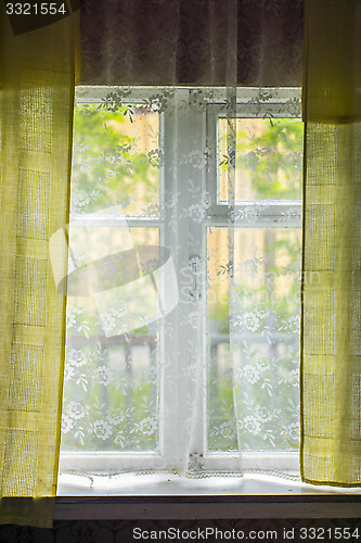 Image of Summer greenery outside rustic window