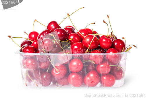 Image of Red juicy sweet cherries in a plastic tray