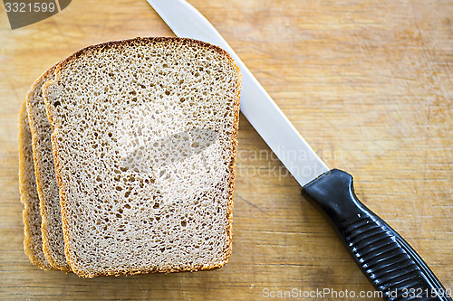 Image of Bread and knife on breadboard