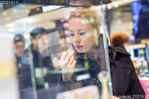 Image of Beautiful woman shopping in beauty store.