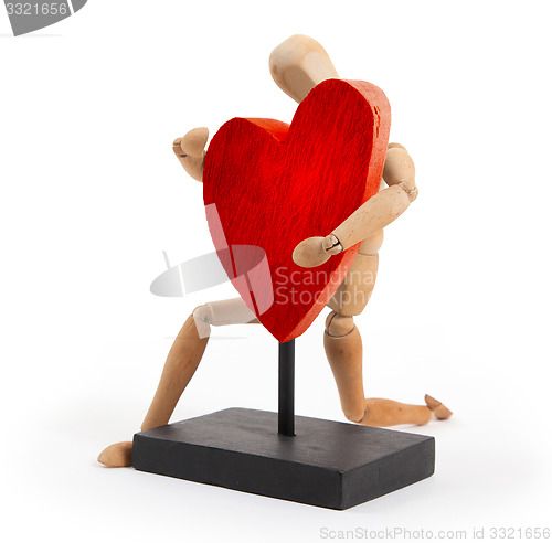 Image of Wooden mannequin with a big heart