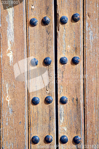 Image of nail dirty stripped paint in the brown wood  