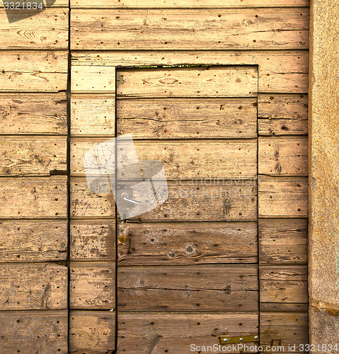 Image of sumirago  brass brown knocker in a  door curch  closed wood ital