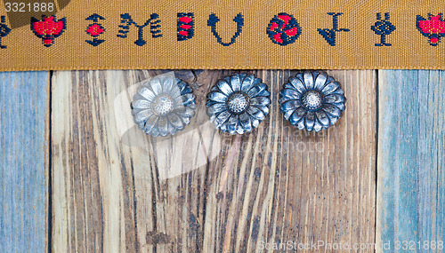 Image of vintage band with embroidered ornaments and old buttons