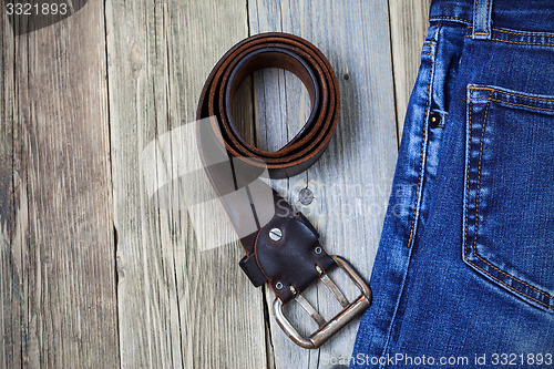 Image of Vintage blue jeans and old leather belt