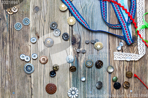 Image of scattered vintage buttons and diverse colored band