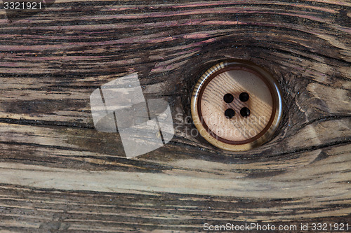 Image of vintage button on old textured boards