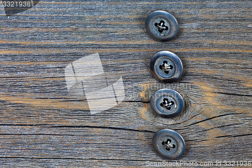 Image of four metal buttons