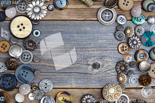 Image of placer of vintage buttons with copy space on textured old boards