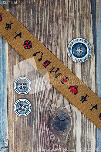 Image of vintage band with embroidered ornaments and old buttons
