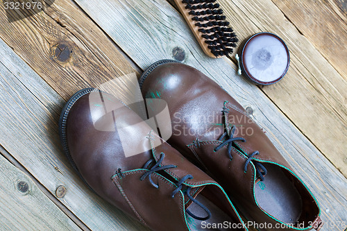 Image of brown boots brush and shoe polish