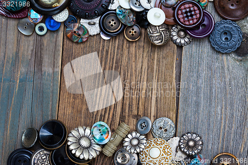 Image of set of vintage buttons on aged boards of old table